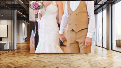 The newlyweds hold hands tightly at the wedding ceremony 2215. Wall mural