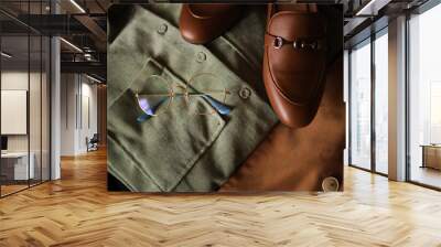 Composition from clothes. Shirts and a jacket with loafers on a dark background. Clothing.  Wall mural