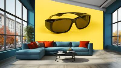 Image of Sunglasses isolated on yellow background. Wall mural