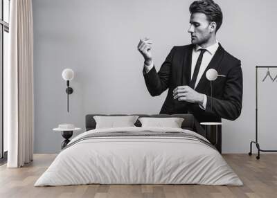 Portrait of young and handsome model in a classic black and white style clothing. Studio shot. Copy space. Wall mural