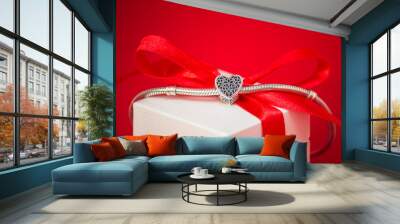  Luxury, trendy jewelry. Delicate and feminine silver charm a small heart. Best gift for Valentines Day and Mothers day. Red heart backgraund. Wall mural