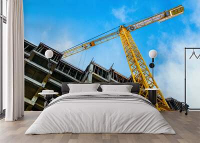 construction site and yellow crane on the background blue sky Wall mural