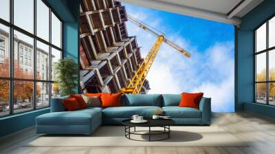 construction site and yellow crane on the background blue sky Wall mural