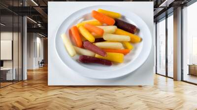 Rainbow baby carrots against white background- healthy food eating concept Wall mural