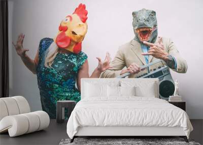 Crazy senior couple wearing chicken and t-rex mask while dancing outdoor - Mature trendy people having fun celebrating and listening music with boombox - Absurd concept of masquerade funny holidays Wall mural