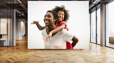 Happy African family on the beach during summer holidays - Afro people having fun on vacation time - Parents love and travel lifestyle concept Wall mural