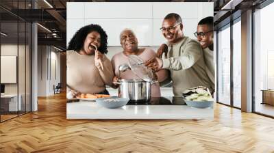 Happy Hispanic family having fun cooking together in modern kitchen - Food and parents unity concept Wall mural