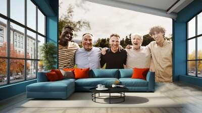 Happy multigenerational group of men with different ethnicities having fun smiling in front of camera at park - People diversity concept Wall mural