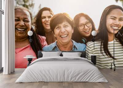 Happy multigenerational women with different ethnicity having fun smiling in front of camera in a public park - Females empowerment concept Wall mural