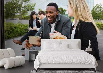 Happy multiracial business people having a lunch break outside office Wall mural