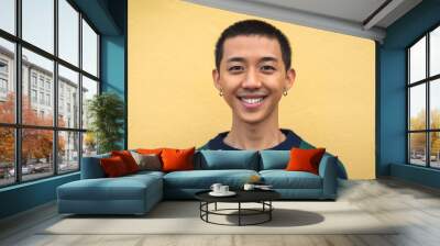 Portrait of happy young Asian teenager smiling in front of camera Wall mural