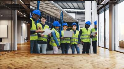 Team of multiracial engineers working in robotic factory - Tech industrial concept Wall mural