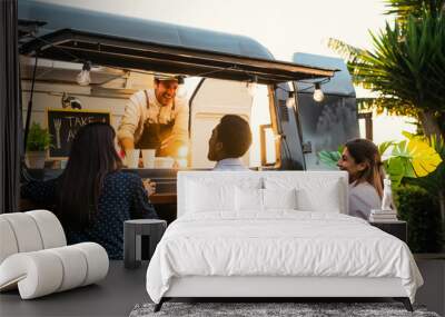 Young people buying meal from street food truck - Modern business and take away concept Wall mural