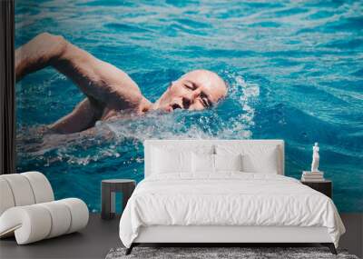 senior man swimming on the blue ocean -health and activity concept. Wall mural