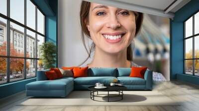 smiling woman sitting on a dentist chair, girl with beautiful teeth in a dental studio, femal patient in a clinic Wall mural