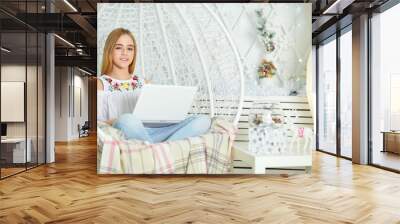 Beautiful cute girl using laptop at home Wall mural