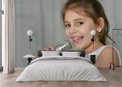 Beautiful little girl with microphone Wall mural