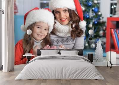 Close up portrait of girl with mother celebrating Christmas Wall mural