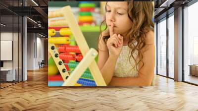 Cute little girl learning to use abacus Wall mural