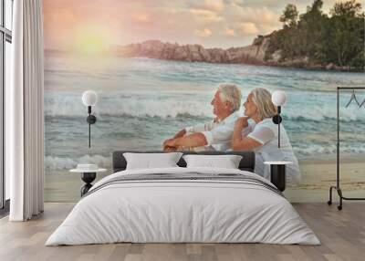 elderly couple rest at tropical beach Wall mural