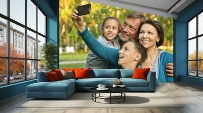 family taking selfie in park Wall mural