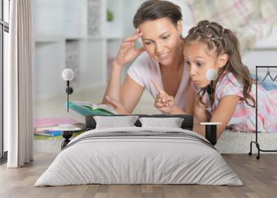 Mother with daughter doing homework Wall mural