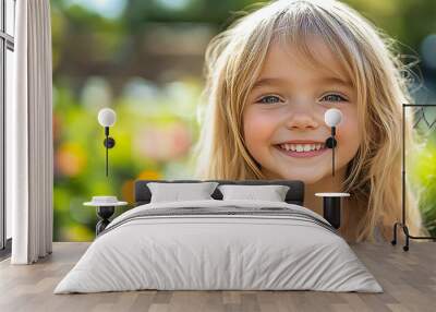 Portrait of a beautiful little girl looking at the camera Wall mural