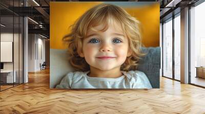 Portrait of a beautiful little girl looking at the camera Wall mural