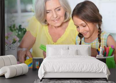 Portrait of a grandmother playing with granddaughter Wall mural