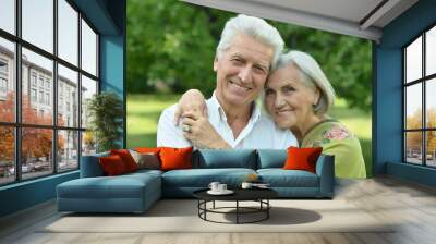 Portrait of mature couple in summer park Wall mural