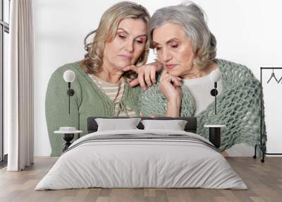 Portrait of two sad women on white background Wall mural