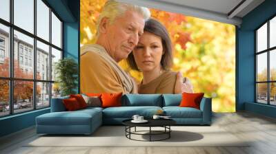 Sad woman and senior man hugging  Wall mural