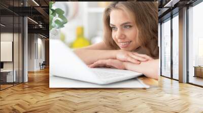 young woman using laptop Wall mural