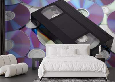 CD vs VHS. VHS cassette lay on the many CD disks Wall mural