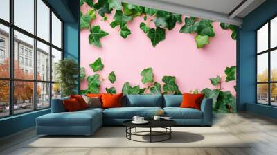 Charming green ivy border gracefully positioned on a soft pink background Wall mural