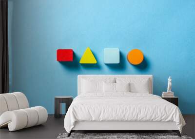 Children's educational toys geometric shapes for logic on a blue background. The concept of education, child development, logic and ingenuity. Flat lay, top view Wall mural