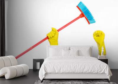 Cleaning the house topic: human hand in yellow rubber gloves holding a red broom isolated on a white background in studio Wall mural