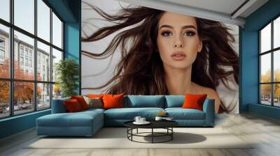 Close-up photo portrait young woman with hair blowing in air beautiful make-up isolated white color background Wall mural