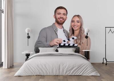 Couple Holding Clapperboard Isolated. Couple Movie Concept Wall mural