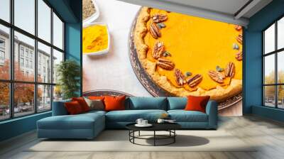 Pumpkin pie decorated with pecans on a served table for an autumn party food Wall mural