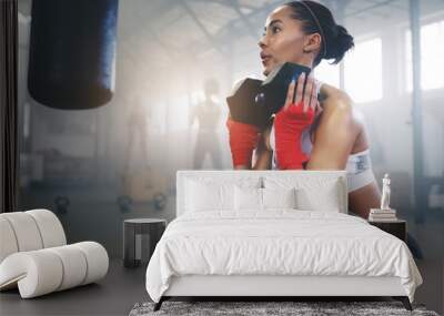 Pressure makes diamonds, hard work makes champions. Cropped shot of a young sportswoman busy working out in the gym. Wall mural