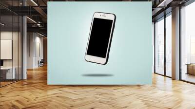 Flying white mobile phone on a blue background. Levitation. Concept applications for phone, mobile device, presentation. Wall mural