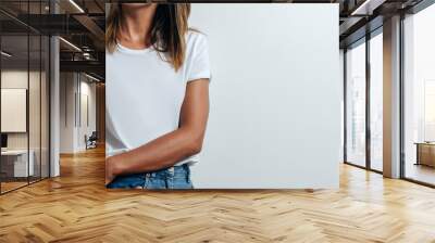 Charming woman in white blank t-shirt, wearing glasses, empty wall, studio portrait. Wide screen, panoramic Wall mural