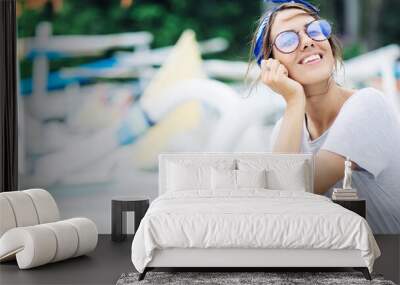 Portrait of young pretty woman in grey dress resting on vacation, wearing eyeglass. Wide screen, panoramic Wall mural