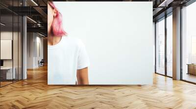 Positive laughs plus size model with white blank t-shirt and pink hear, empty grunge wall background Wall mural