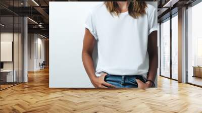 Pretty woman in white blank t-shirt, empty wall, studio close-up Wall mural