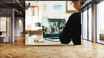 Woman has video call with her team using laptop and camera Wall mural