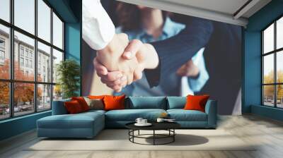 Young business people shaking hands in the office. Finishing successful meeting. Three persons. Wide screen panoramic Wall mural