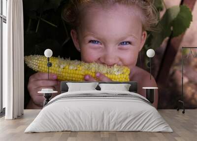 Girl with corn under natural light. Girl with vegetables. Real people Wall mural