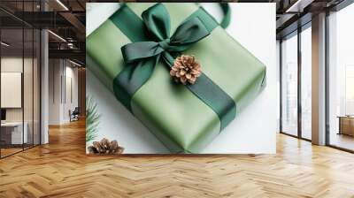 Green gift box with satin ribbon and pine cone decoration Wall mural